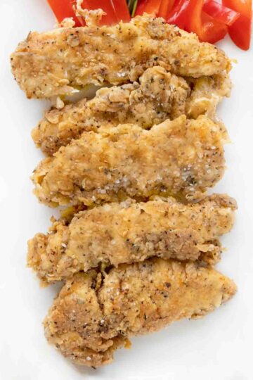 Spicy Fried Chicken Tenders on a white platter.