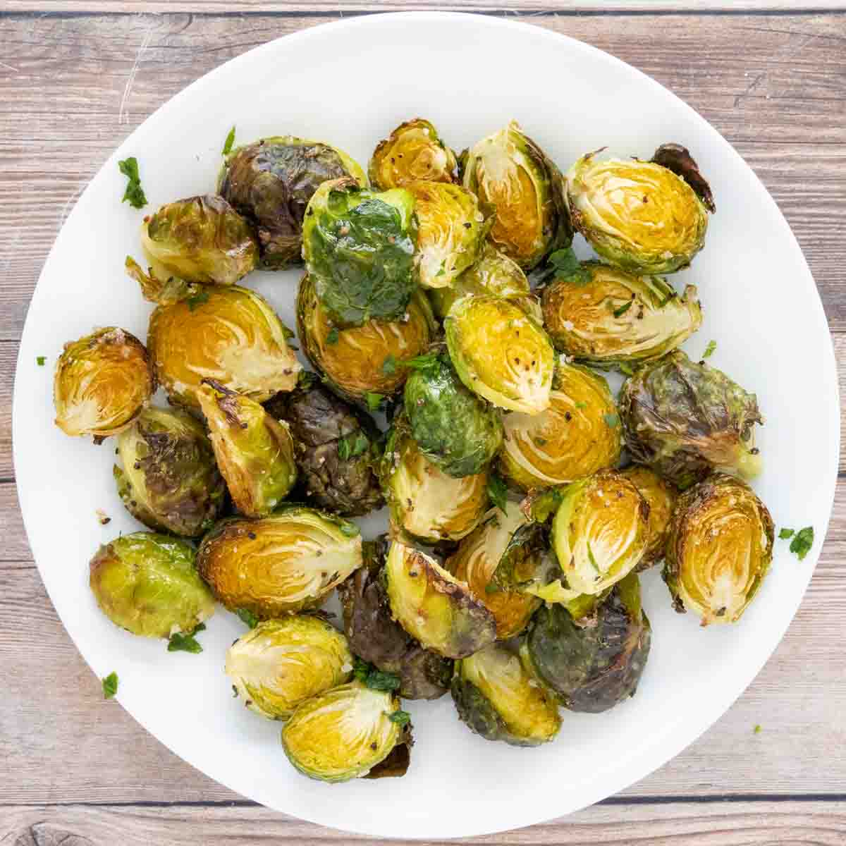 roasted brussels sprouts on a white plate.