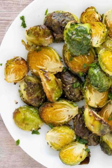 roasted brussels sprouts on a white plate.