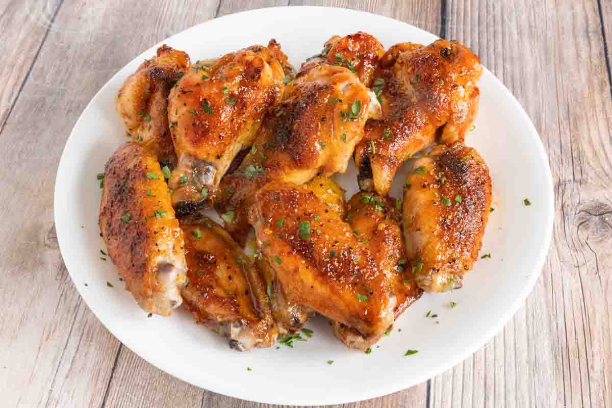 Honey Sriracha Chicken Wings on a white platter.