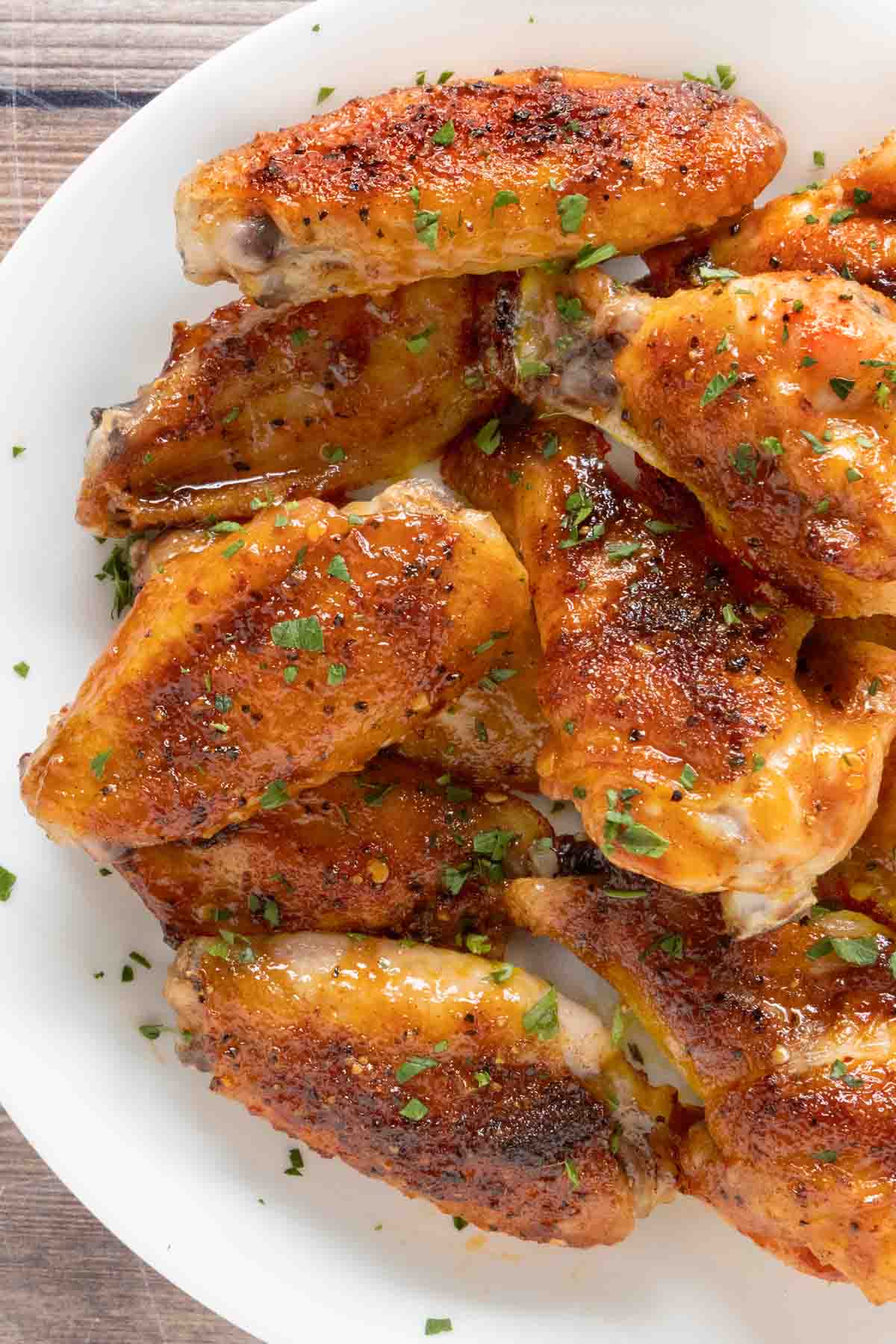 Honey Sriracha Chicken Wings on a white platter.