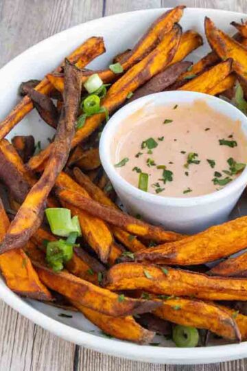 Air fryer-cooked sweet potatoes with a side of spicy mayo.