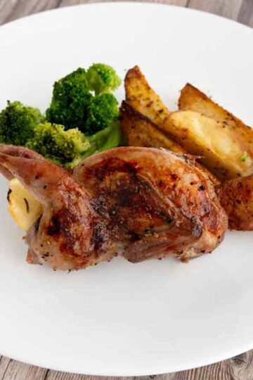 Picture of roasted quail with potatoes and broccoli.